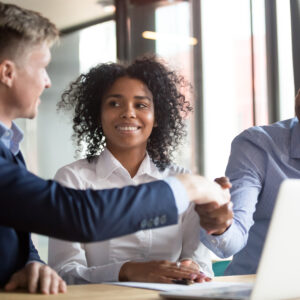 Investors smile while gesturing at computer.jpg