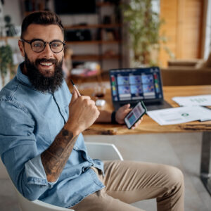 Happy stock investor holding smartphone.jpg