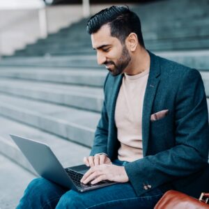 Urlhttps3A2F2Fg.foolcdn.com2Feditorial2Fimages2F8628472Fbusiness trader laptop smiling.jpg