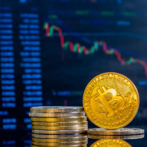 Closeup golden bitcoins dark reflective surface histogram decreasing crypto scaled.jpg